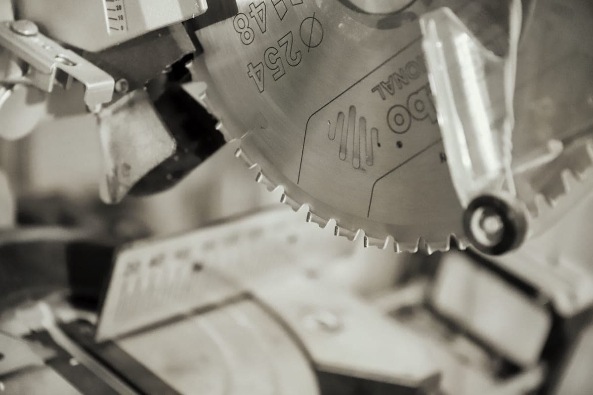 A hacksaw cutting through metal on a workbench