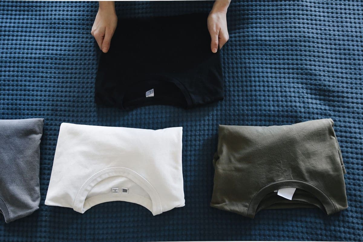Neatly folded colored T-shirts laid out flat
