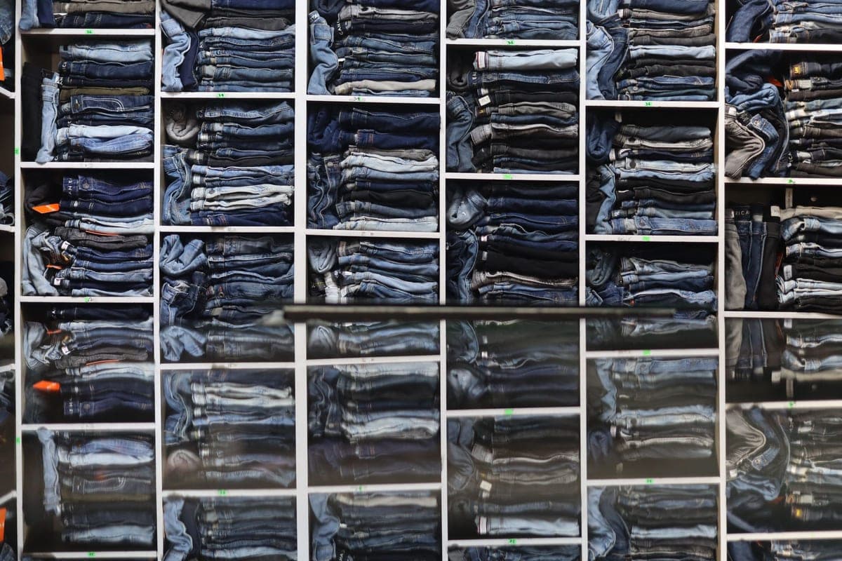 Folded clothing arranged on open shelving