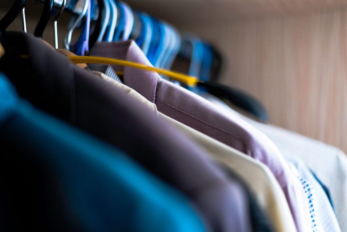 A row of matching clothes hangers on a rail
