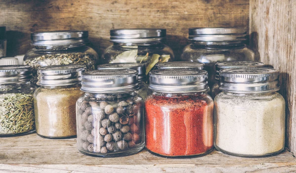 Spice jars arranged on a kitchen rack