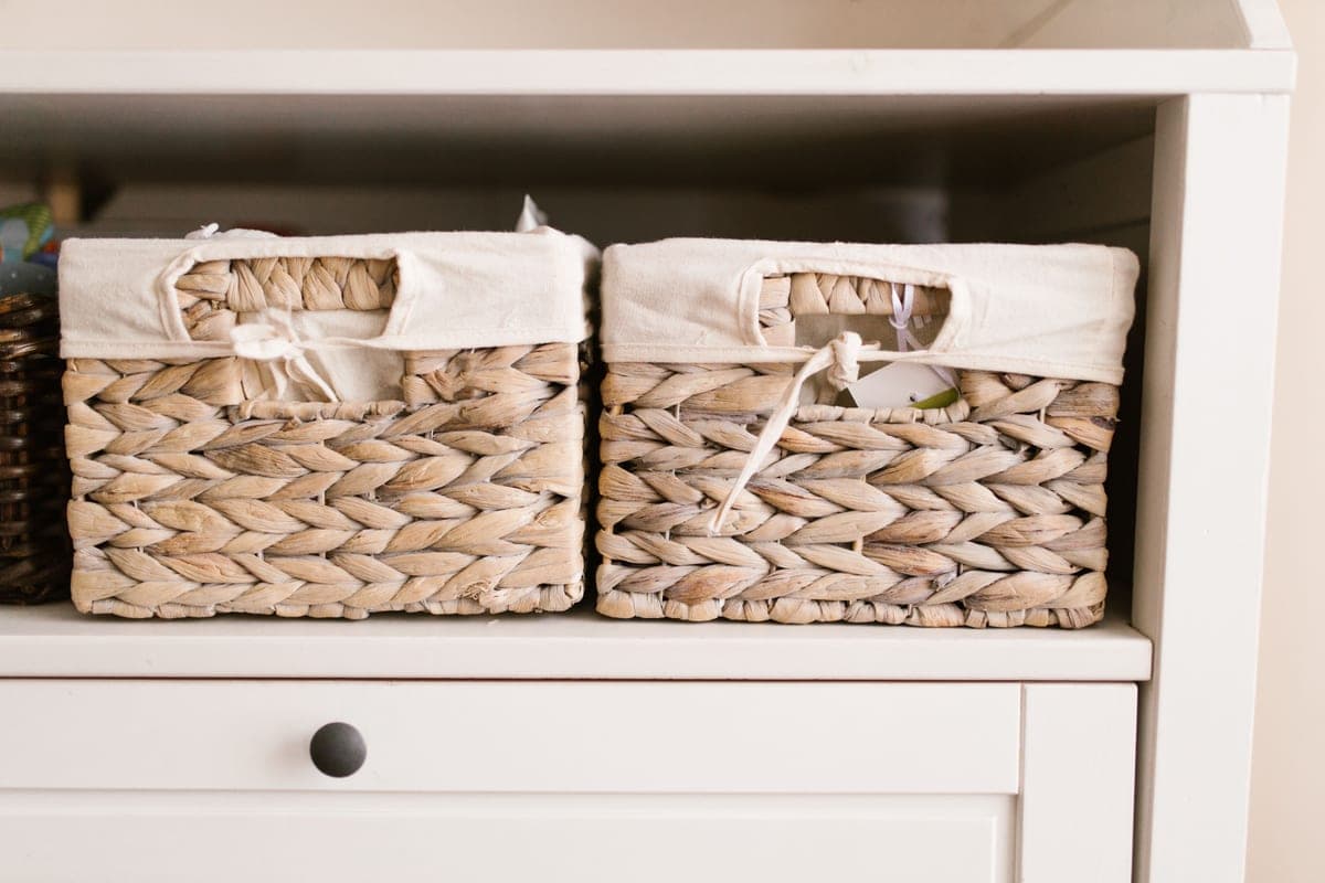 Fabric storage bins on a closet shelf