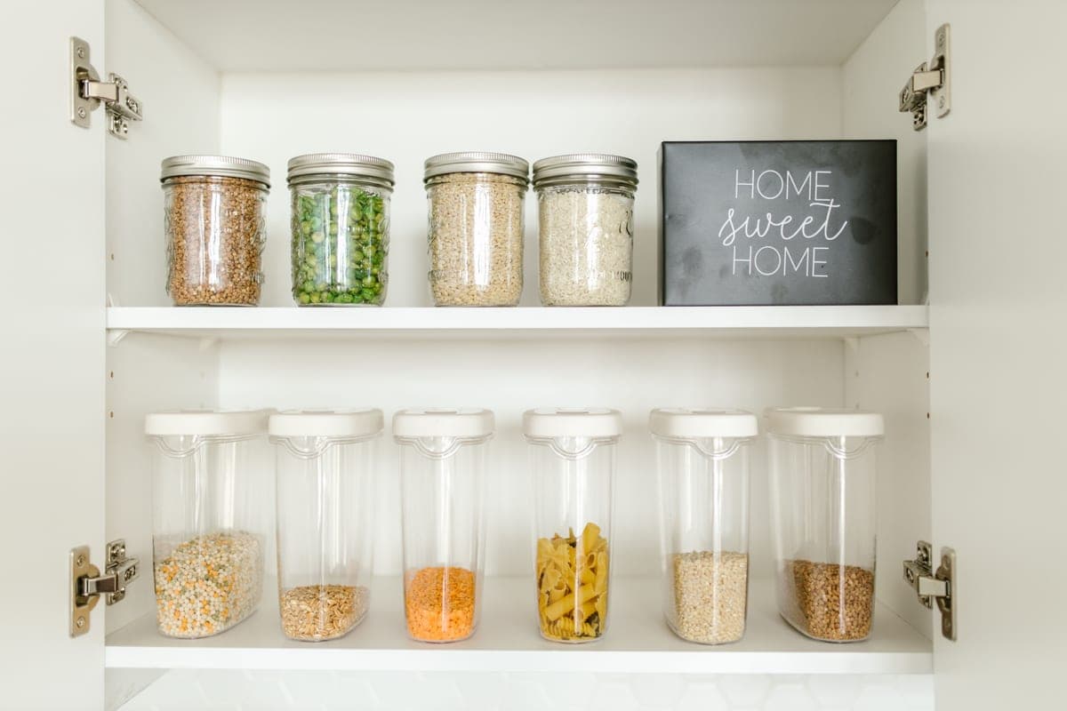 Clear labeled storage containers holding dry goods