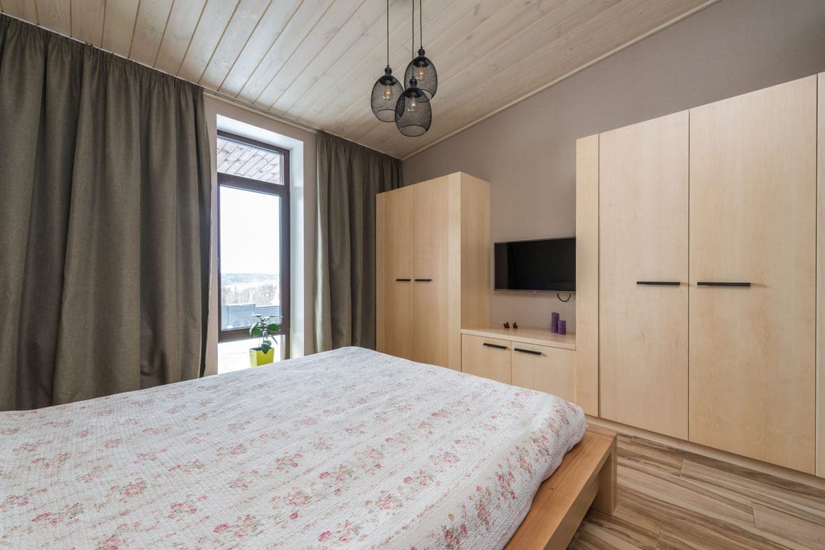 A freestanding wardrobe cabinet in a bedroom